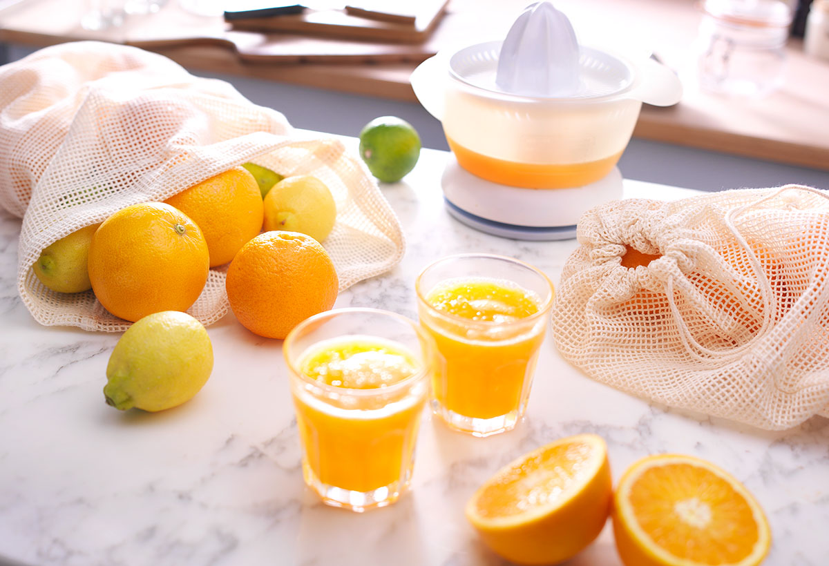 Drinks photography of two orange juices glasses with orange, lemon and a orange juicer made by Studio_m Photography Amsterdam