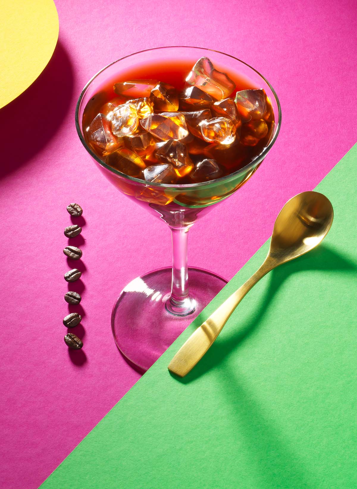 Drinks photography of a coffee cocktail with coffee beans and a golden spoon made by Studio_m Photography Amsterdam