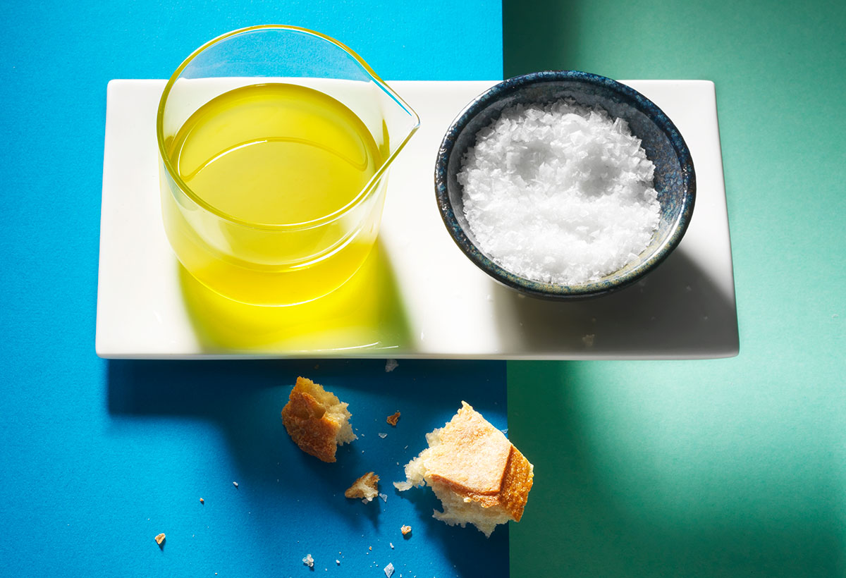 Food photography of basil oil and a bowl of sea salt